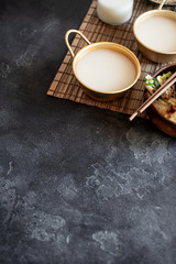 Makgeolli rice wine is one of the oldest korean traditional fermented alcoholic drinks on dark...