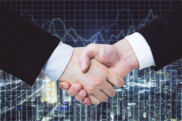 handshake on glowing night city background with forex chart.
