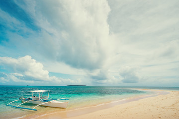 Beautiful landscape with tropical white sand beach with fishing boats. Siargao Island, Philippines.