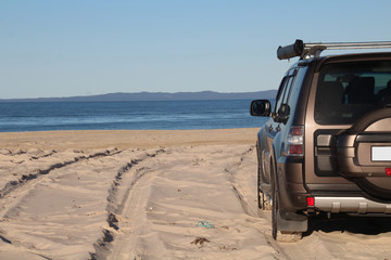 SUV on the beach sand - Travel and exploring related concept
