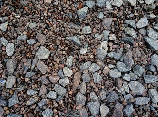 Stone texture background. Crushed gravel as background or texture. Granite gravel. Granite crumb close-up. Bbackground. Texture. Brown. Structure.