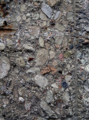 Ruined old concrete fence with the addition of stone and broken granite.