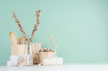 Natural beige wood cosmetics accessories in green mint menthe bathroom interior - bath sponge,...