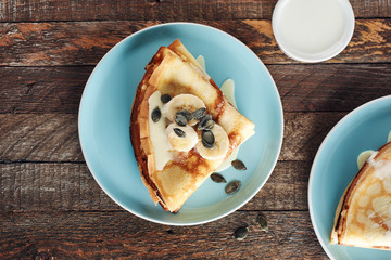 Thin pancakes with bananas and condensed milk.