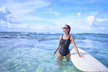 Extreme Water Sport. Surfing. Healthy Athletic Young Surfer Girl With Sexy Fit Body Holding Surf Board While Standing In Clear Water, Summer Vacation. Lifestyle. Leisure, Hobby, Wellness, Fitness.