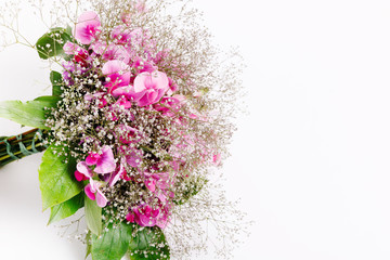 Spring airy bouquet of purple flowers sweet peas and gypsophila