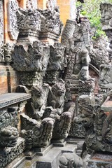Carved stone gargoyles, demons, deities and other ornaments on a Hindu temple in Bali Indonesia