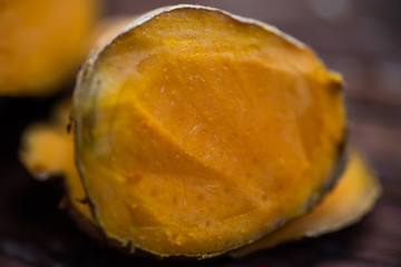 Close up yellow turmeric on wood table.