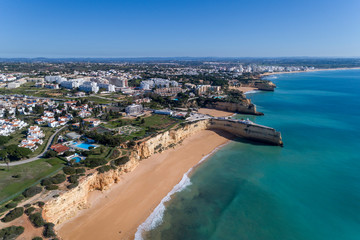 Aerial drone photo of the beautiful coastline along Porches with the Nova and Senhora da Rocha...