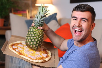 Funny man holding pineapple and pizza 