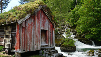 Log cabin and waterfall in Norway 