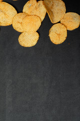 Pile of potato chips. Crisps on background. Potato chips is snack in bag