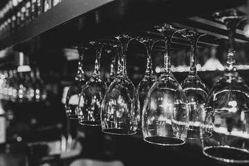 crystal wine glasses hung upside down in black and white