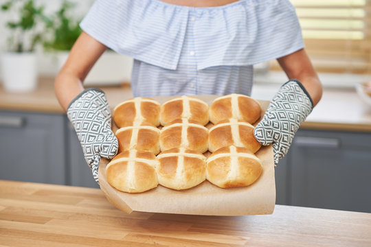 Happy Adult Woman Preparing Hot Cross Buns For Easter In The Kitchen