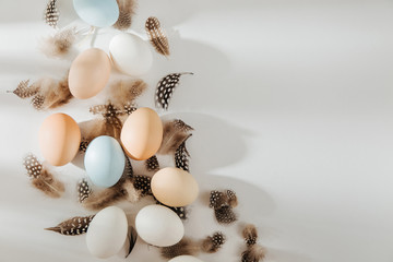 Natural Colored brown, quail and white Eggs with sunlights. Compositions in pastel colors. Easter consept.  Flat lay, top view .