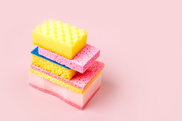 Sponges on pink background. Cleaning or housekeeping concept background. Copy space. Flat lay, Top view.