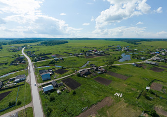 Aerial view of small river in Lipovskoe village. A lot of grass and trees. Russia, Sverdlovsk region