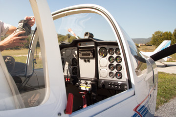 Fototapeta na wymiar Twoseater Aircraft Dashboard and Open Cockpit on Airstrip