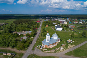Aerial view of church in Lipovskoe village. A lot of grass and trees. Russia, Sverdlovsk region
