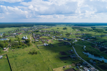 Aerial view of Lipovskoe village with church and small river. A lot of grass and trees. Russia, Sverdlovsk region