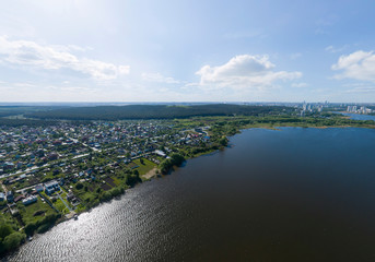 Aerial view of private houses near the bank of Iset river in Ekaterinburg city. Summer day, sunny. Russia