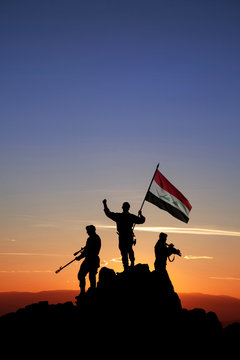 Three Armed Soldiers With The Iraqi Flag