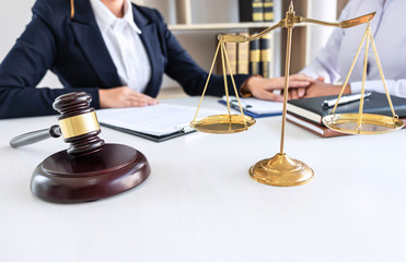 Professional female lawyer or counselor discussing negotiation legal case with client meeting with...