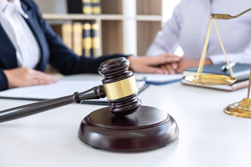 Professional Female lawyer discussing negotiation legal case with client meeting with document...