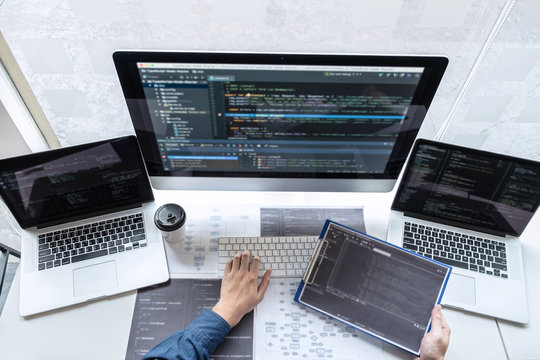 Developer programmer working on project in software development computer in IT company office, Writing codes and data code website and coding database technologies to find solution to problem
