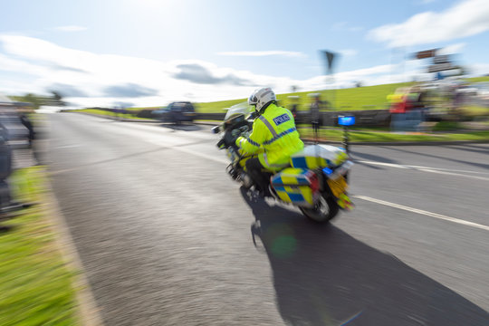 British police motorcycle traveling at high speed with motion blur