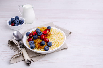 Wheat porridge with fruit and berries