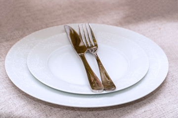 Fork and knife on a clean white plate