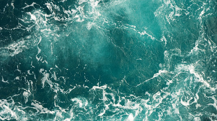 Background of the sea, clean deep ocean with air bubbles, foam on the surface of the ocean. foam composition on blue turquoise water.