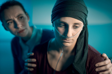 Woman assisting her friend with cancer at the hospital