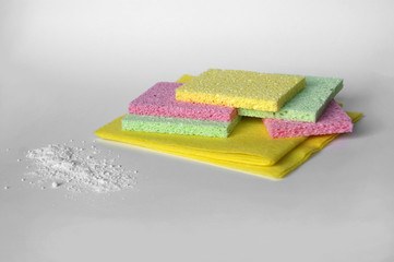 Scattered cleaning powder and microfiber cloths and washcloths.