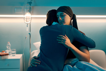 Woman comforting her friend with cancer at the hospital