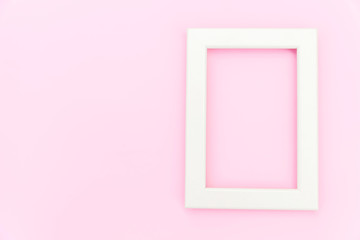 Simply design with empty pink frame isolated on pink pastel colorful background. Top view, flat lay, copy space, mock up. Minimal concept.