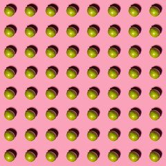 Limes pattern on pink background. Creative food concept. Flat lay.