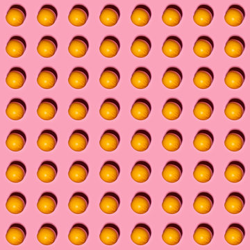 Orange pattern on pink background. Creative food concept. Flat lay