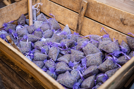 Fototapeta Group of delicate dried lavender bouquets with lila textile material, displayed for sale at an weekend deco fair for handmade artisans, selective focus. dried lavender flowers, displayed for sale