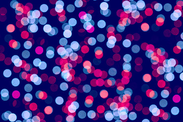 Blurred pink and blue lights on black.