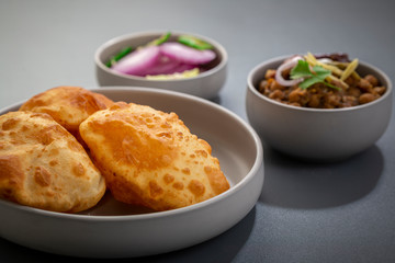 choley bhature is a dish originated initially in the northern part of the Indian subcontinent.  It is a combination of chana masala and bhatura, a fried bread made from maida.