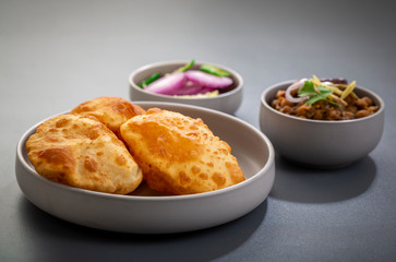 choley bhature is a dish originated initially in the northern part of the Indian subcontinent.  It is a combination of chana masala and bhatura, a fried bread made from maida.