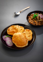 choley bhature is a dish originated initially in the northern part of the Indian subcontinent.  It is a combination of chana masala and bhatura, a fried bread made from maida.