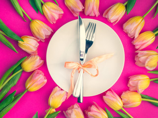 composition for Easter with tulip and plate with cutlery