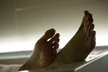 Feet in the bathroom closeup. Steamed female heels. Manicure. - obrazy, fototapety, plakaty
