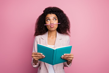 Photo of funny childish dark skin student lady hold copybook book not reading playing pen make fake mustache wear checkered blazer isolated pastel pink color background