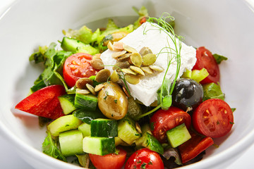 Greek salad in white bowl
