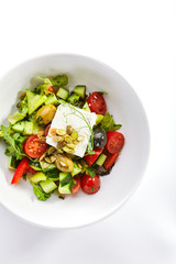 Greek salad in white bowl