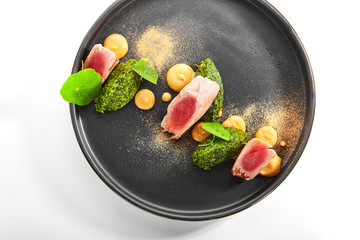Tuna fillet with stewed spinach top view